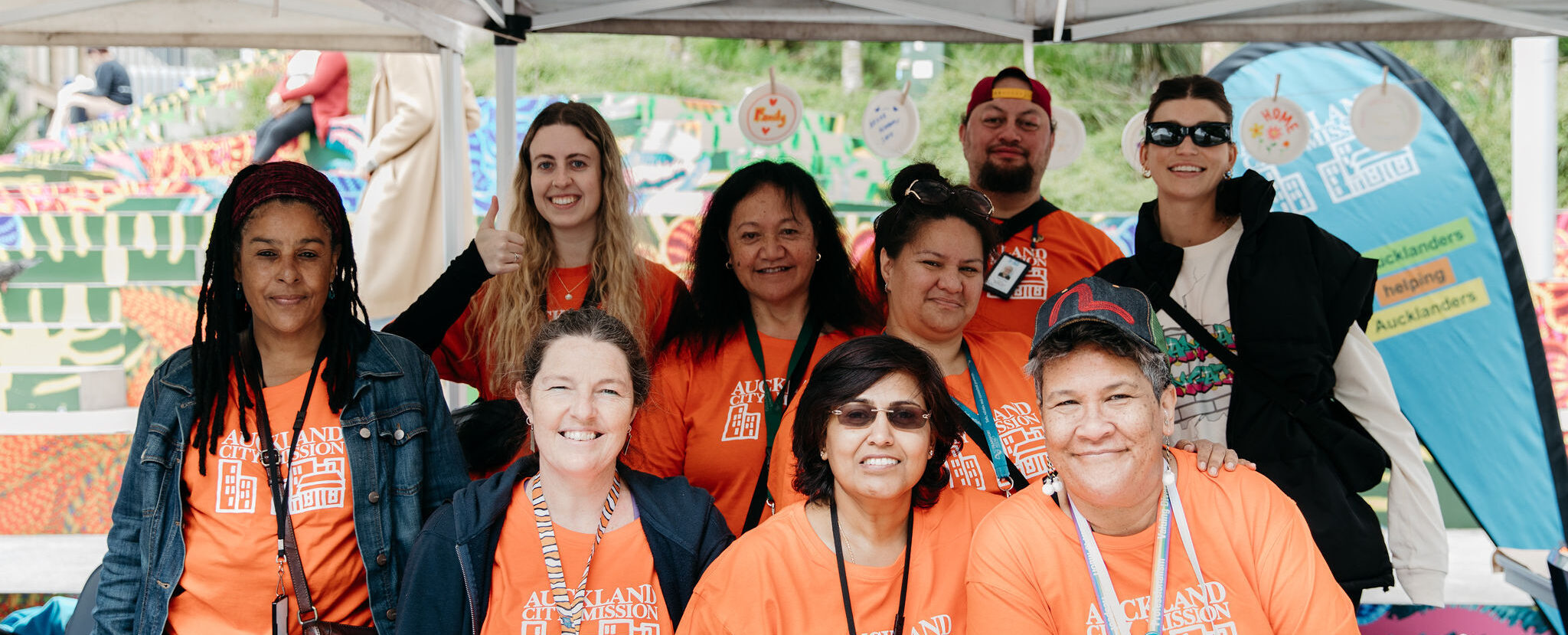 A picture of radiant Auckland City Mission staff on the ground at a World Homeless Day event 2022